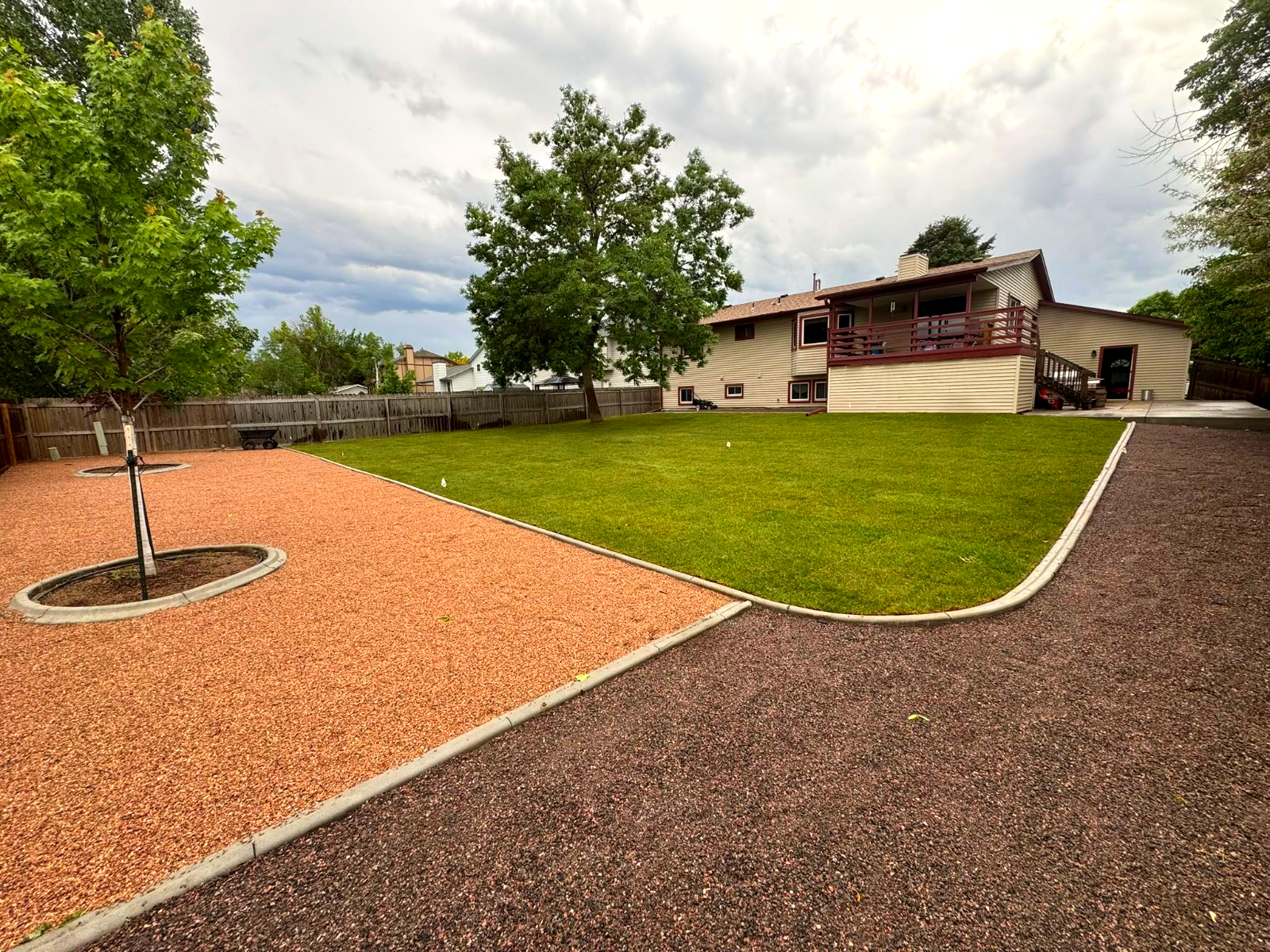 Fresh sod lawn with concrete edging and rock beds
